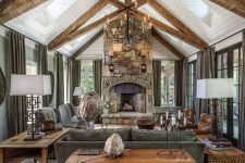 a cozy living room with a stone fireplace