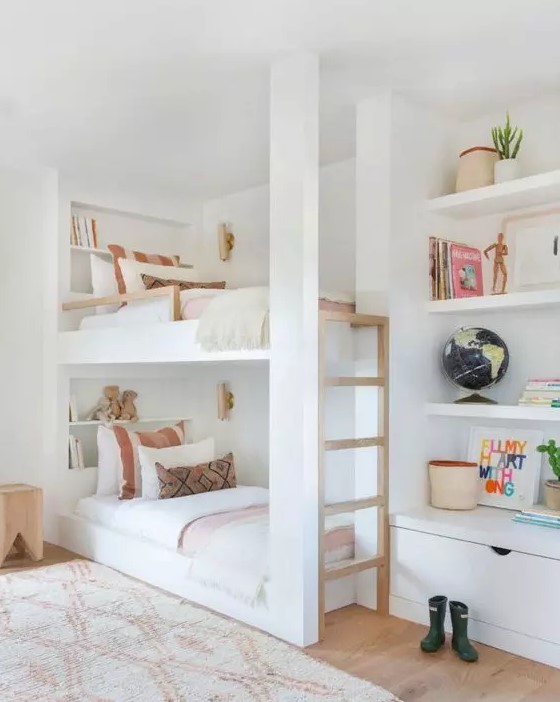a chic neutral kids' bedroom with a bunk bed with a wooden ladder, built-in shelves and a drawer, cool printed textiles