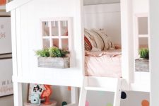 a chic shared bedroom with a house-shaped bunkbed with pink and green bedding, some orange and green touches in decor