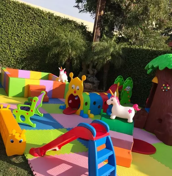 a colorful and fun kids' playspace with various toys, slides, a ball box and a mini playhouse is a cool idea for any outdoors
