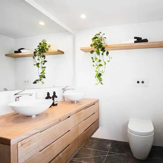a contemporary neutral bathroom of light stained wood, with drawers and lights doesn't take any floor space perfectly matching the style