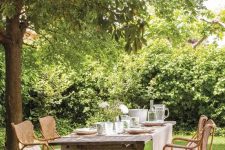 a lovely garden dining area with rattan chairs