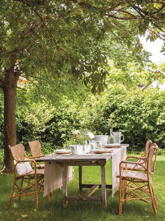 a lovely garden dining area with rattan chairs