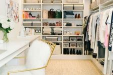 a glam cloffice with a neutral rug, a large open closet, a white double desk, a gold and white fur chair