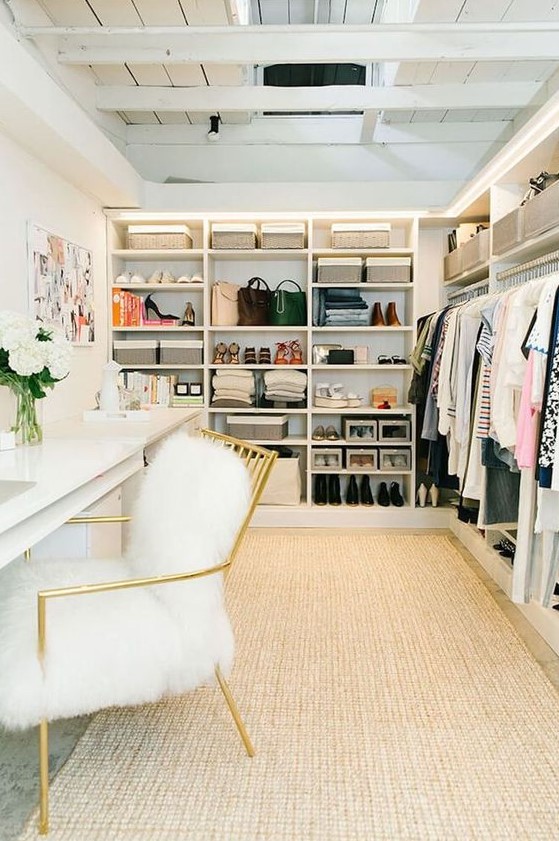 a glam cloffice with a neutral rug, a large open closet, a white double desk, a gold and white fur chair