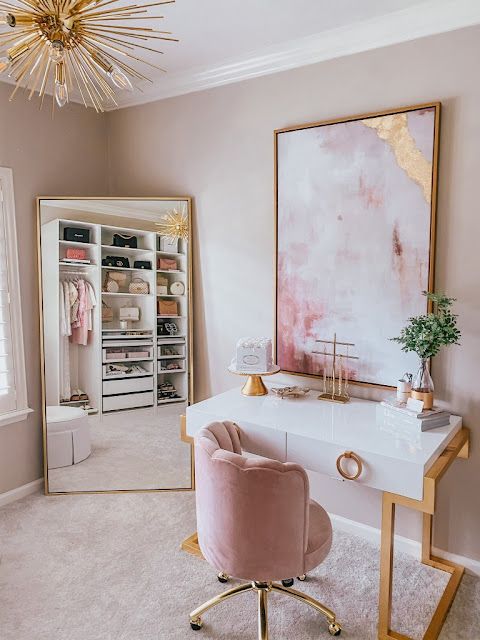 a glam pink and white cloffice with an IKEA closet, a large floor mirror, a white and gold desk, a pink chair and a beautiful marble artwork