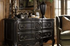 a heavy dark wood sideboard with antique decor, a mirror and a dark vase is a gorgeous idea for any space