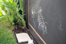 a large chalkboard and colorful chalk will inspire your kids’ creativity outdoors, too