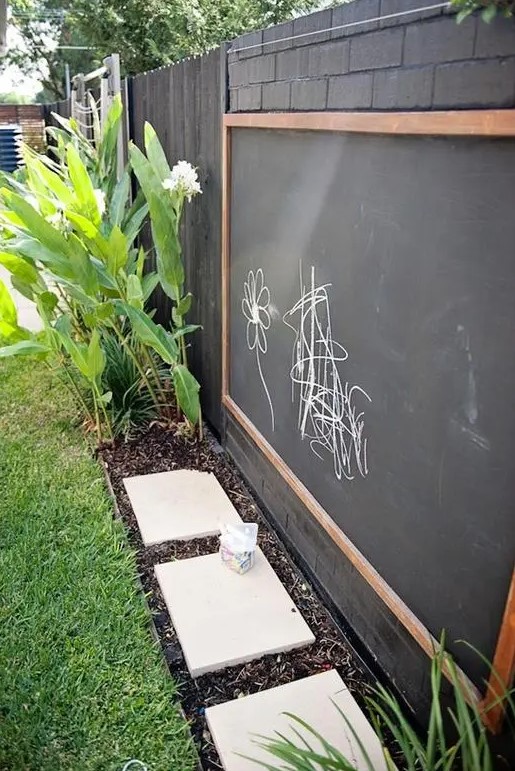 a large chalkboard and colorful chalk will inspire your kids' creativity outdoors, too