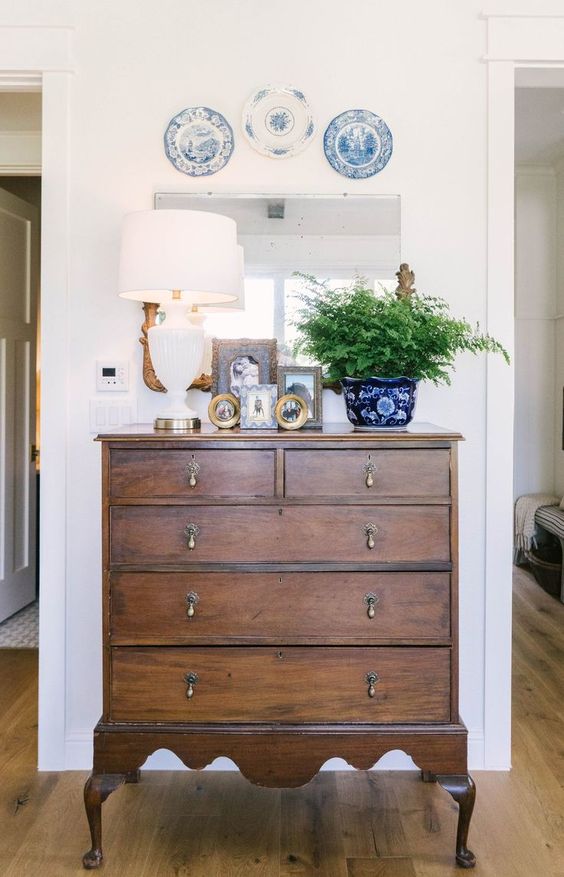 a lovely stained vintage dresser with vintage handles is a lovely idea for a small entryway or an awkward nook that you want to use for storage
