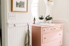 a pink vintage dresser turned into a chic bathroom vanity will add a soft touch of color to the space and will provide a lot of storage space