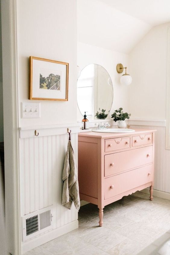 a pink vintage dresser turned into a chic bathroom vanity will add a soft touch of color to the space and will provide a lot of storage space