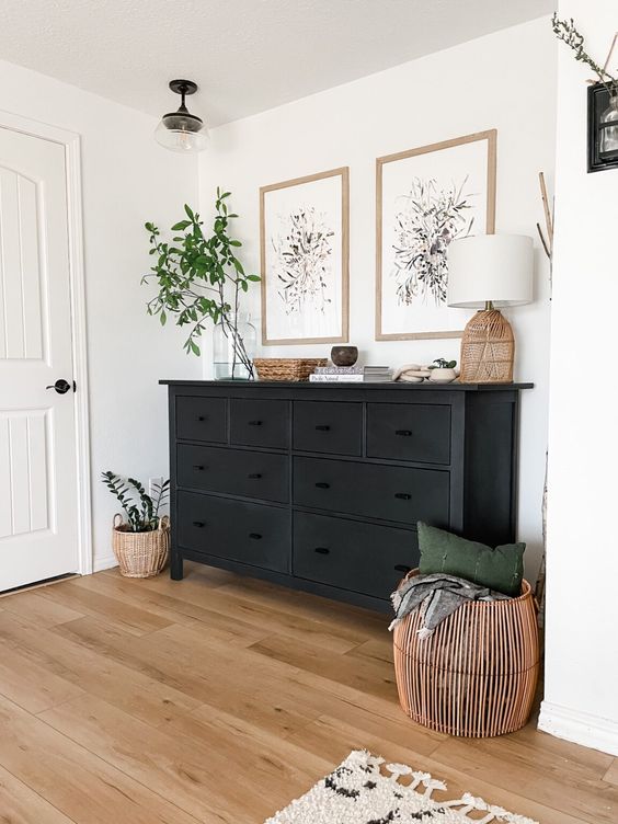 a pretty black vintage dresser is a timeless idea for a mid-century modern or farmhouse space, loosk fresh with greenery and botanical posters