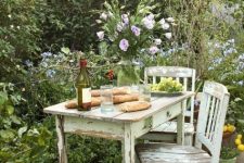 a shabby chic garden dining space in the greenery and blooms, with pastel shabby chic furniture is a cool idea for many gardens