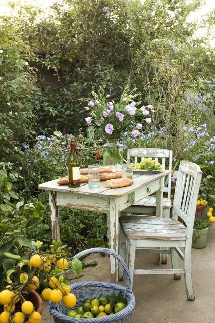 a shabby chic garden dining space in the greenery and blooms, with pastel shabby chic furniture is a cool idea for many gardens