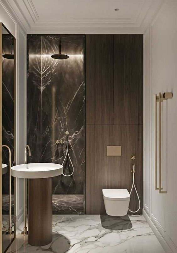 a sophisticated minimalist bathroom with a brown marble shower space, dark stained wood, a catchy round sink