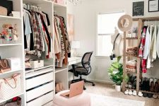 a stylish and girlish cloffice with a white desk, a black chair, a pink storage pouf, open storage units, a makeshift closet and drawers for clothes