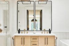 a stylish light-stained plywood floating vanity with a white stone countertop and black handles looks eye-catchy and matches the style of the space