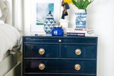 a vintage navy dresser with gold knobs is a chic idea for a vintage bedroom as it can double as a cool storage nightstand