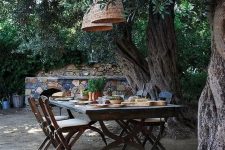 a vintage rustic dining area with a vintage table and folding wooden chairs, rattan lamps is a very cozy space