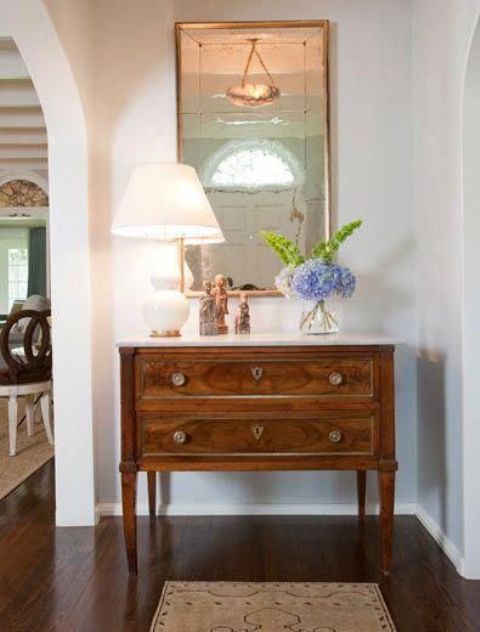 a vintage stained dresser like this one will be a nice solution for an elegant and chic entryway, a cool alternative to a usual large console table