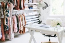 an airy and girlish home office with a floral wallpaper wall, a vast makeshift closet with open shelving, a trestle desk and a white fur chair
