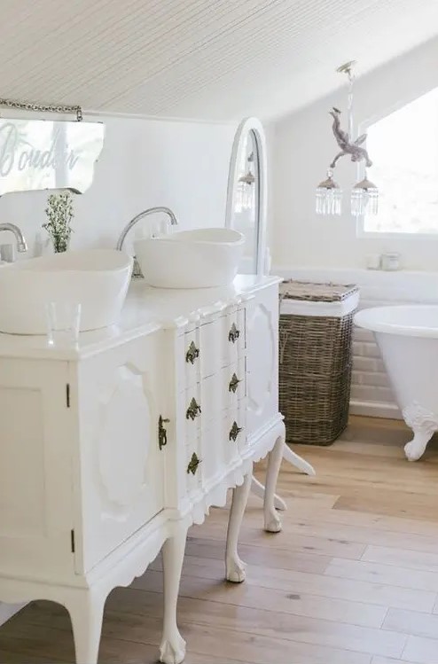 an exquisite white vintage dresser with drawers is a beautiful vanity for a countryside or French inspired bathroom