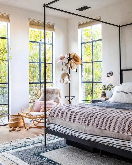 floor to ceiling windows create a light feeling in the bedroom, welcome outdoors indoors and fill the space with natural light