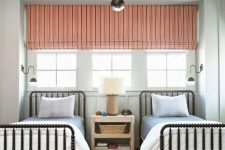 05 a chic shared guest bedroom with a triple window covered with a coral shade and a printed rug