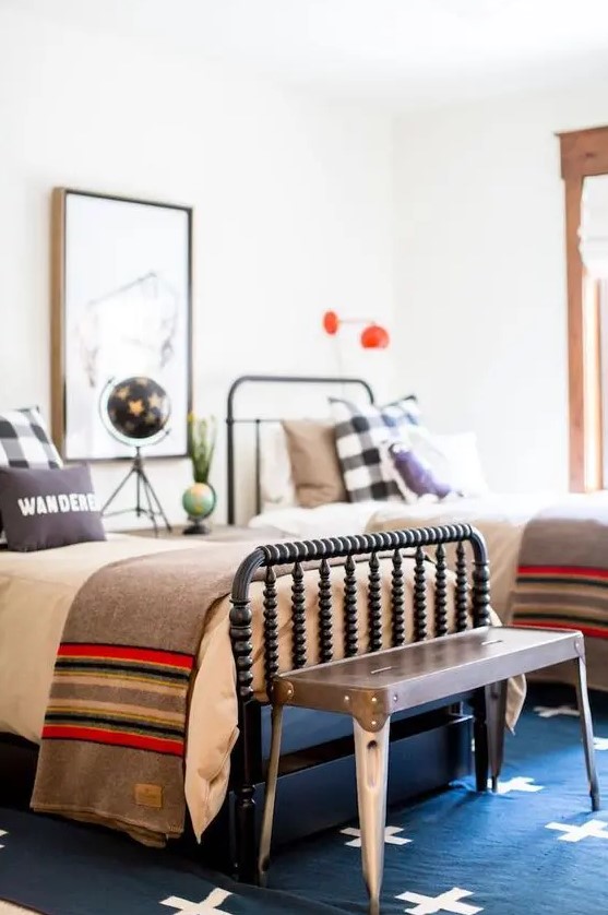 a colorful guest bedroom with two beds, various textiles and catchy lamps and accessories
