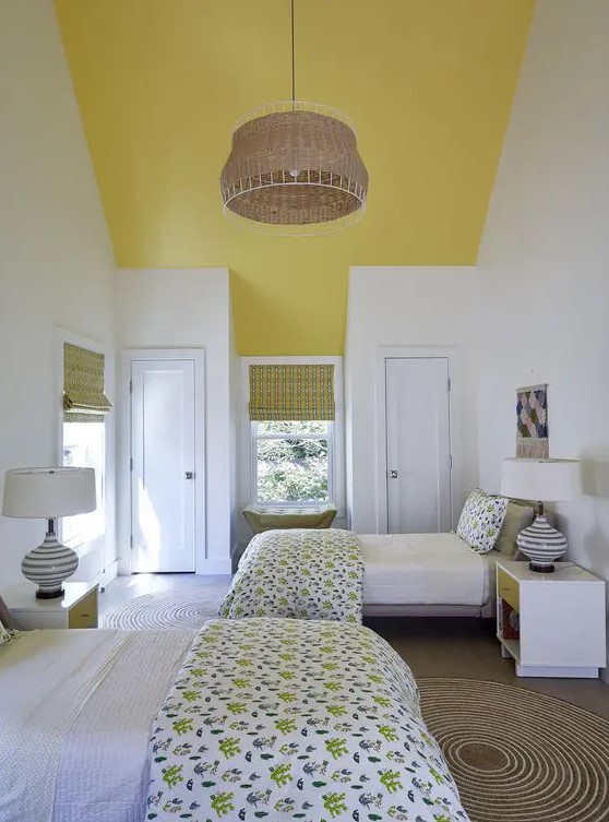 a lively twin guest bedroom with sunny yellow touches, printed textiles and several windows