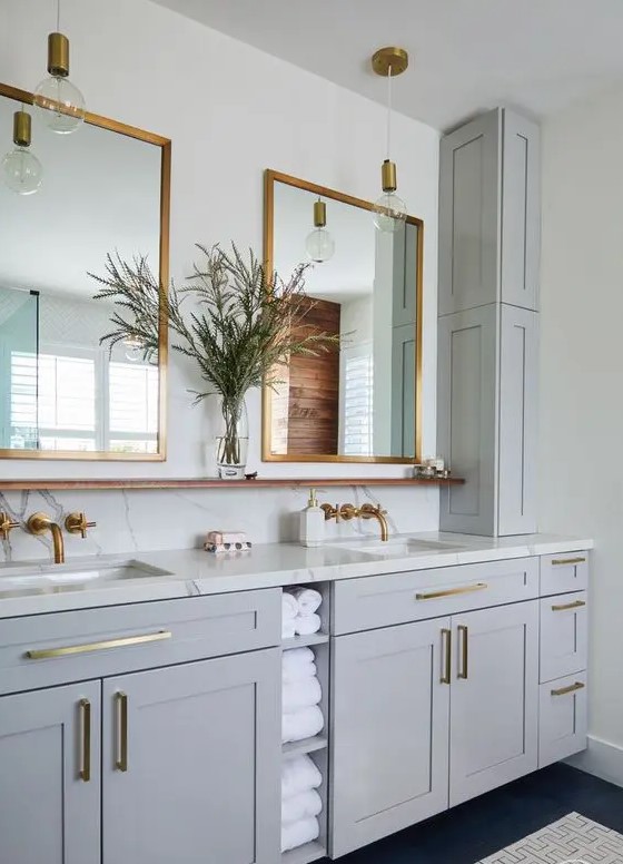 a light grey bathroom done with kitchen cabinets, a white stone countertop and a backsplash, a double sink and mirrror is super chic