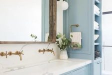 22 a lovely coastal bathroom done with light blue kitchen cabinets and a vanity that matches, with a white stone countertop