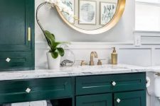 23 a bright and chic bathroom with dark green kitchen cabinetry, a penny tile floor, some gold touches for more chic