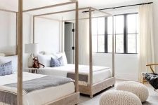 24 a modern beach twin guest bedroom with canopy beds, knit ottomans and much natural light