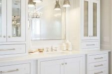 24 an elegant and stylish creamy bathroom made with vintage kitchen cabinets, a mirror in a metallic frame and vintage pendant lamps