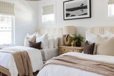 25 a neutral coastal shared guest bedroom with stained beds and neutral bedding, artwork and a woven pendant lamp is amazing