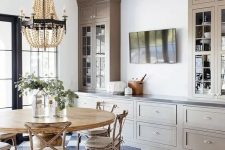 26 a beautiful farmhouse dining room done with grey kitchen cabinets, a wooden dining set and a wooden bead chandelier