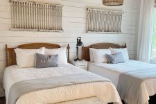 26 a neutral farmhouse guest bedroom with stained beds, neutral bedding, white shabby chic ladders and whitewashed chests on casters
