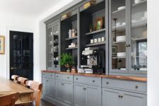 29 a formal farmhouse dining room with a whole wall taken by grey kitchen cabinets, a vintage wooden dining set