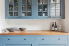 32 a blue home bar done with kitchen cabinets, wooden beams and a wooden countertop is a stylish diea for any home