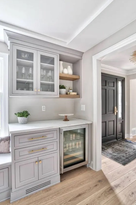 a light grey home bar done with kitchen cabinets, open shelves and a wine cooler is a lovely space for a farmhouse home