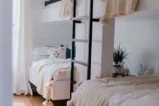 39 a cozy guest bedroom with two bunk beds and a ladder, with much natural light and pompom blankets