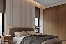 a beautiful contemporary bedroom with built-in lights, a grey upholstered bed, grey bedding and curtains, wooden nightstands and a sleek storage unit