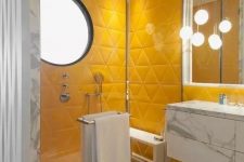 a bright contemporary bathroom with yellow triangle tile shower space, white marble and pendant lamps