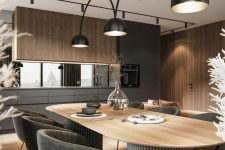 a catchy and moody contemporary dining room with a curved table on grey statement legs, grey chairs and a lovely pendant lamp featuring three shades