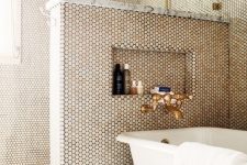 a lovely bathroom with penny tiles on walls