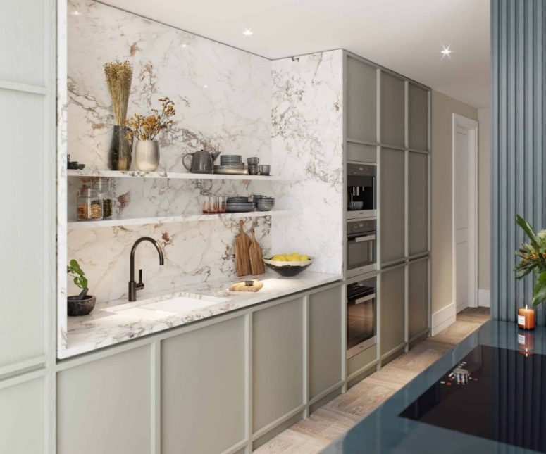a chic contemporary kitchen with light grey no hardware cabinets, a white marble backsplash and countertops, built-in lights