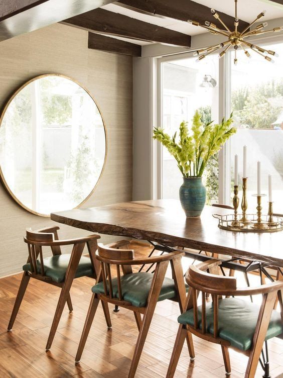 a chic greige dining room with greige walls done with grasscloth wallpaper, a living edge table and green chairs is amazing