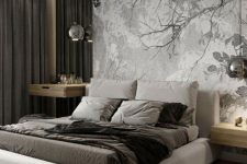 a conemporary bedroom in the shades of grey, with an upholstered bed, an accent floral wall, pendant lamps and floating nightstands